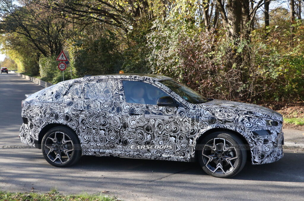 2024 BMW iX2 EV Spied With A Covered Grille And Sloping Roofline ...