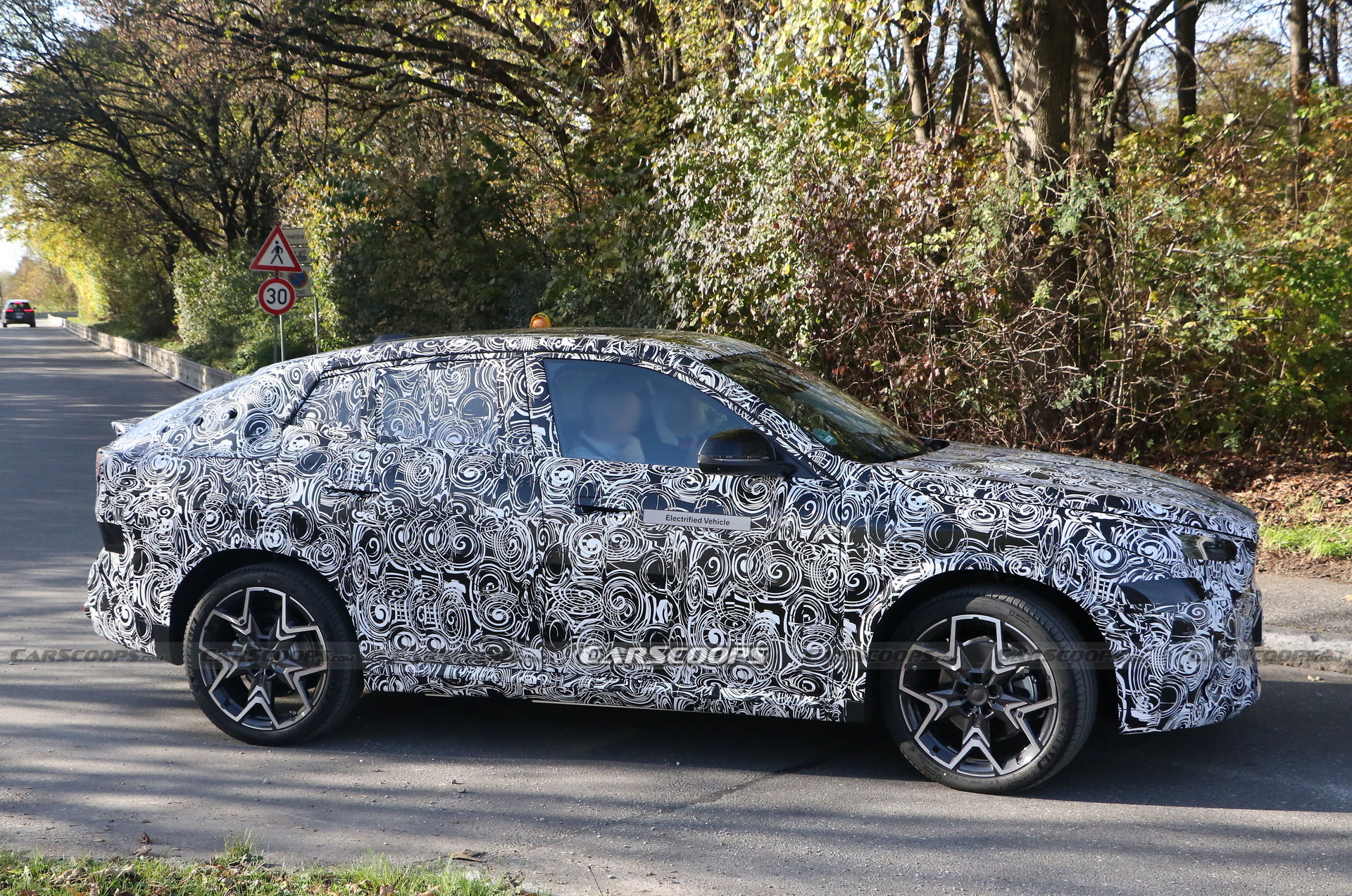 2024 BMW iX2 EV Spied With A Covered Grille And Sloping Roofline ...