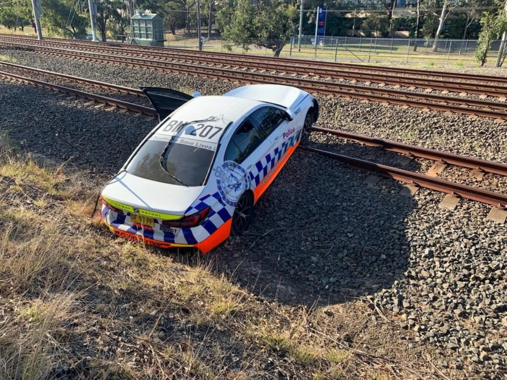  Train Narrowly Misses BMW Police Car Stuck On Tracks After Botched Chase